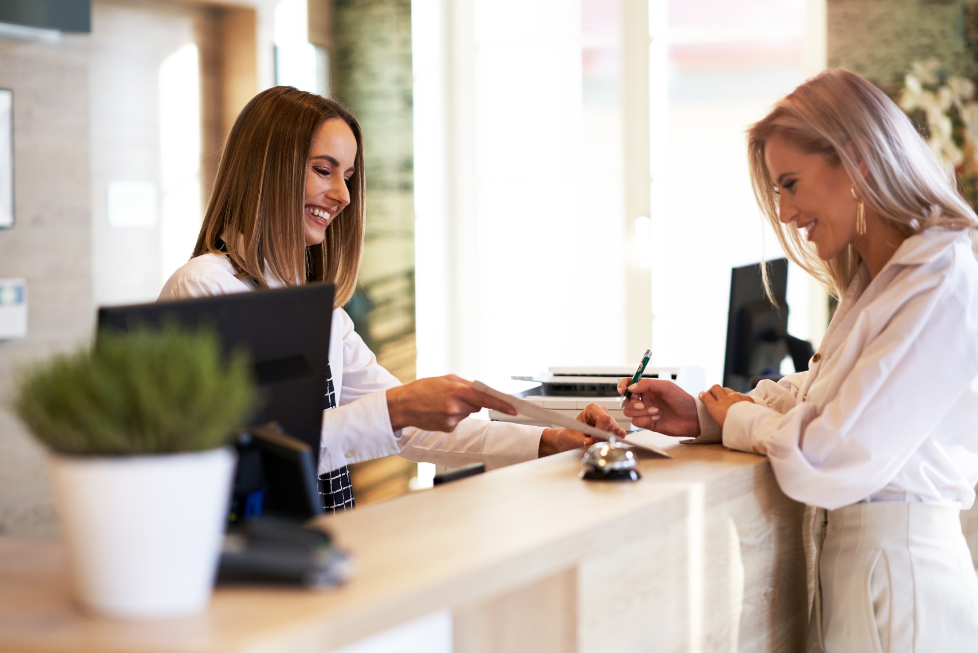 Receptionists smiling at front desk