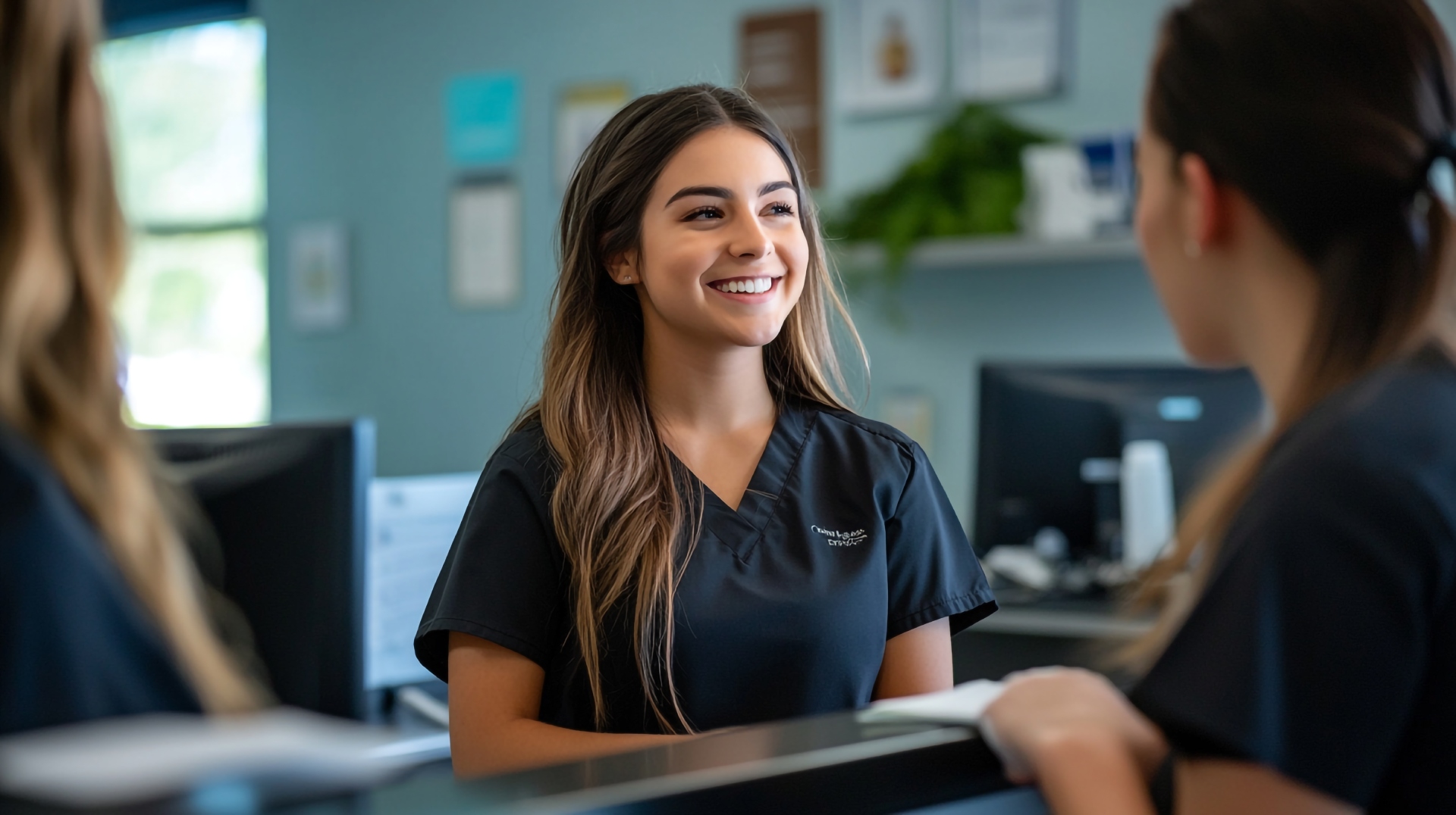 Smiling female healthcare receptionist in a GP surgery representing proven results from EMMA by QuantumLoopAI, the AI reception for NHS GP surgeries that answers every call instantly and improves patient access and staff efficiency.